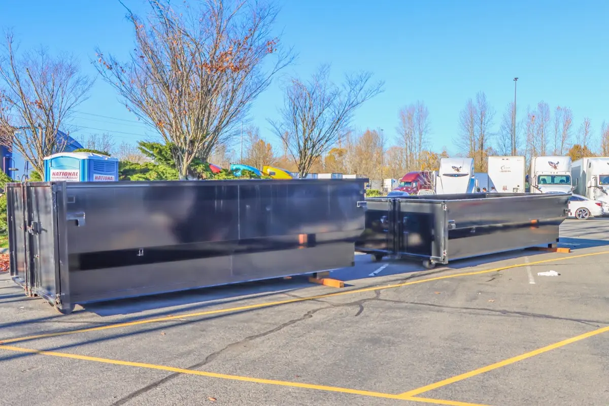 Professional dumpster rental service with roll-off container on residential driveway in Parkland